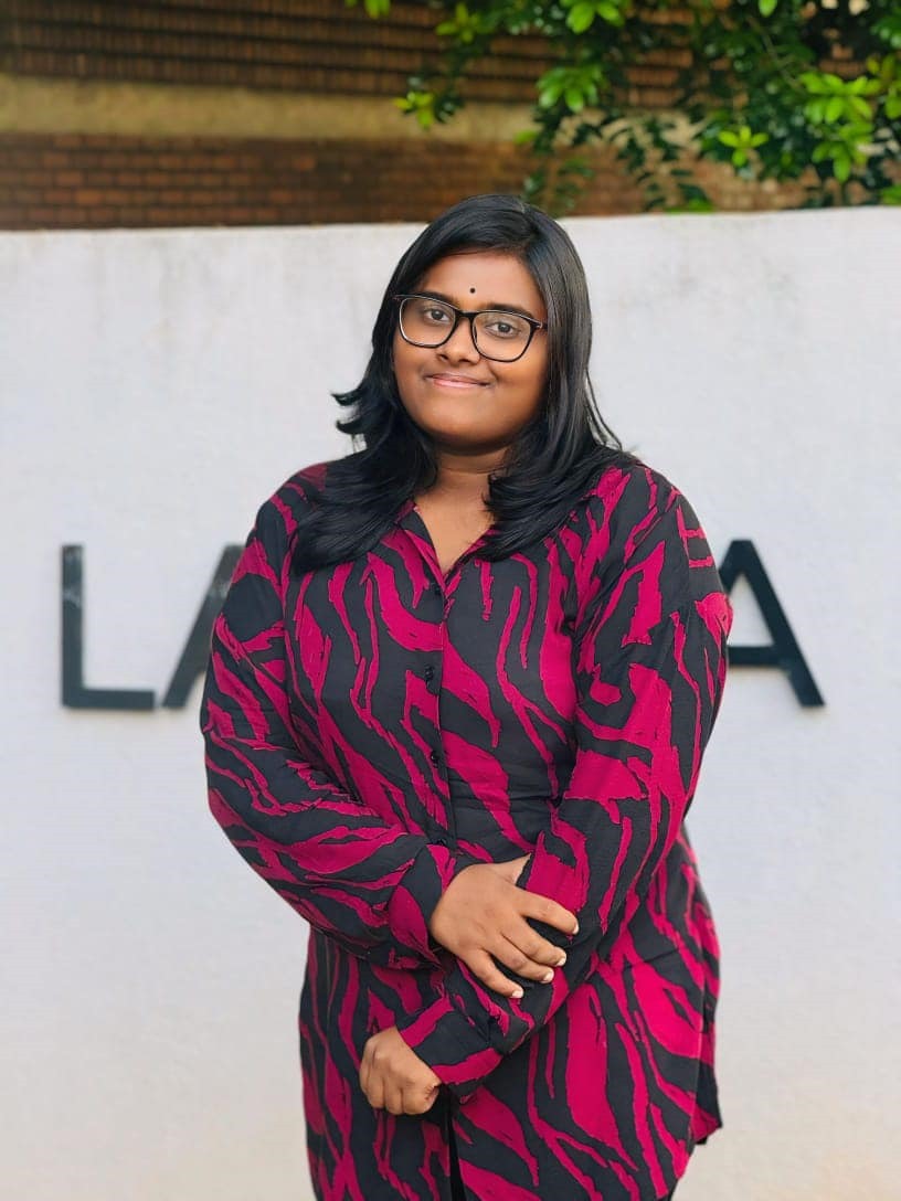 Portrait of Madhusha Joseph Wimalagaran, Magazine Editor of the Tamil Student Association, smiling and wearing formal attire, standing in a university or event setting. If visible, text in the image: Madhusha Joseph Wimalagaran Magazine Editor. The atmosphere is welcoming and professional.