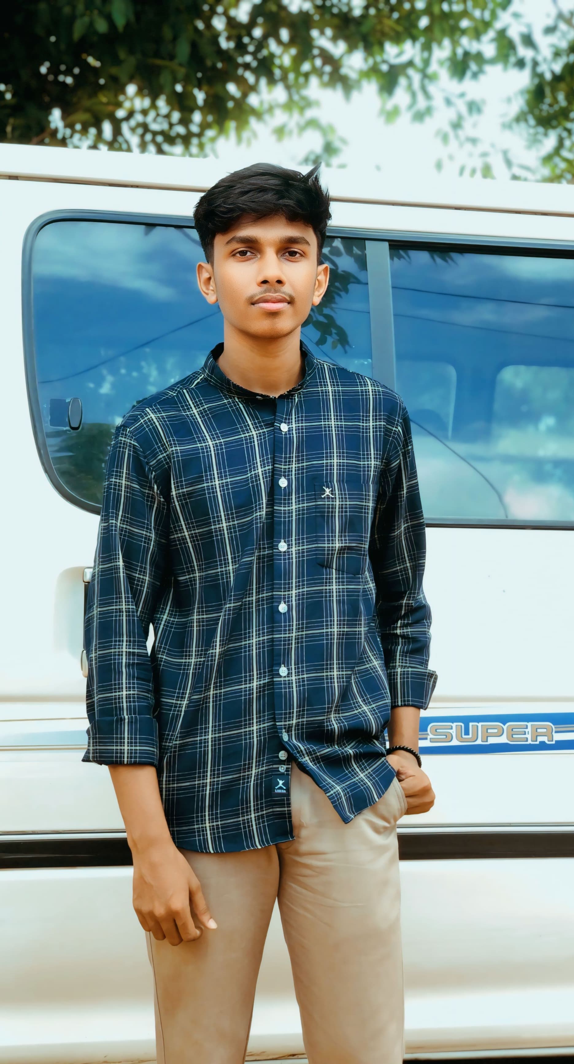 Portrait of Napithan Yoganathan, Junior Treasurer of the Tamil Student Association, smiling and wearing formal attire, standing in a university or event setting. If visible, text in the image: Napithan Yoganathan Junior Treasurer. The atmosphere is welcoming and professional.