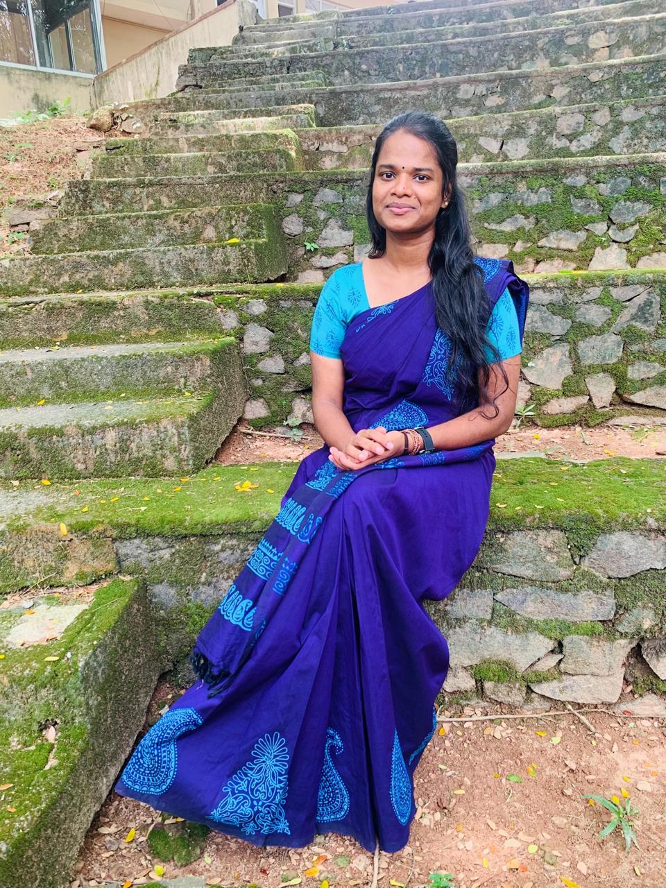 Portrait of Sethuppriya Puvanenthirarasa, Secretary of the Tamil Student Association, smiling and wearing formal attire, standing in a university or event setting. If visible, text in the image: Sethuppriya Puvanenthirarasa Secretary. The atmosphere is welcoming and professional.